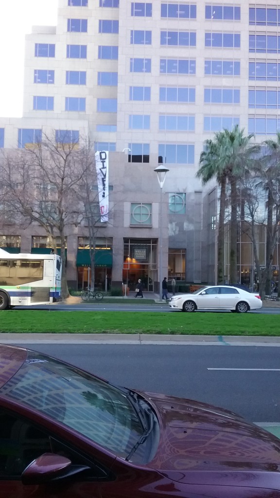 A building with a long banner reading "Divest No DAPL" hanging from the roof