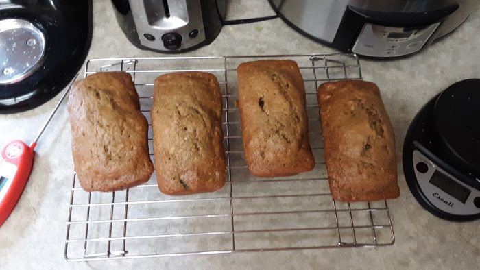 snall loaves of zucchini bread on a cooling rack