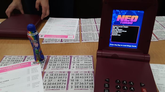 electronic bingo machine next to my paper bingo cards