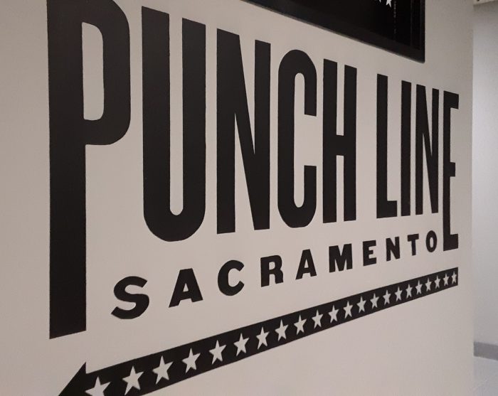 photo of a painted sign that says "Punch Line Sacramento"