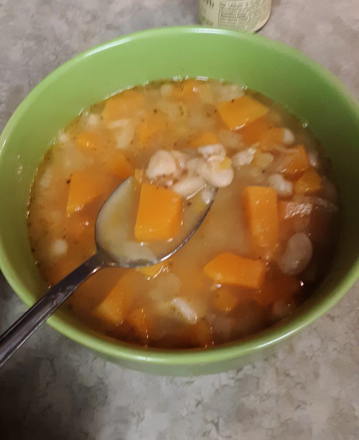 a bowl of white bean and butternut squash soup