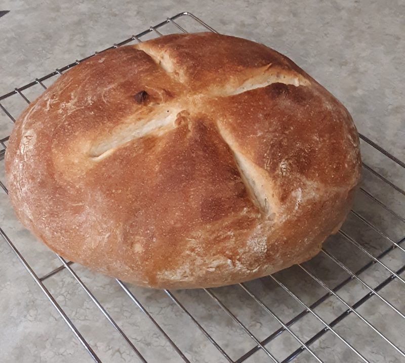 a round loaf of bread with an x scored on top