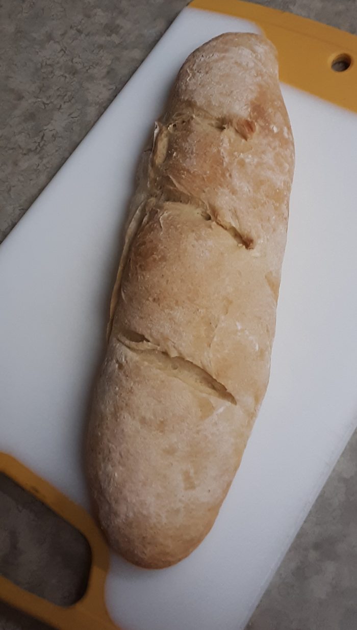 a thin loaf of bread on a cutting board