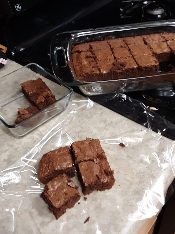 a pan of brownies, plus some brownies being wrapped in plastic