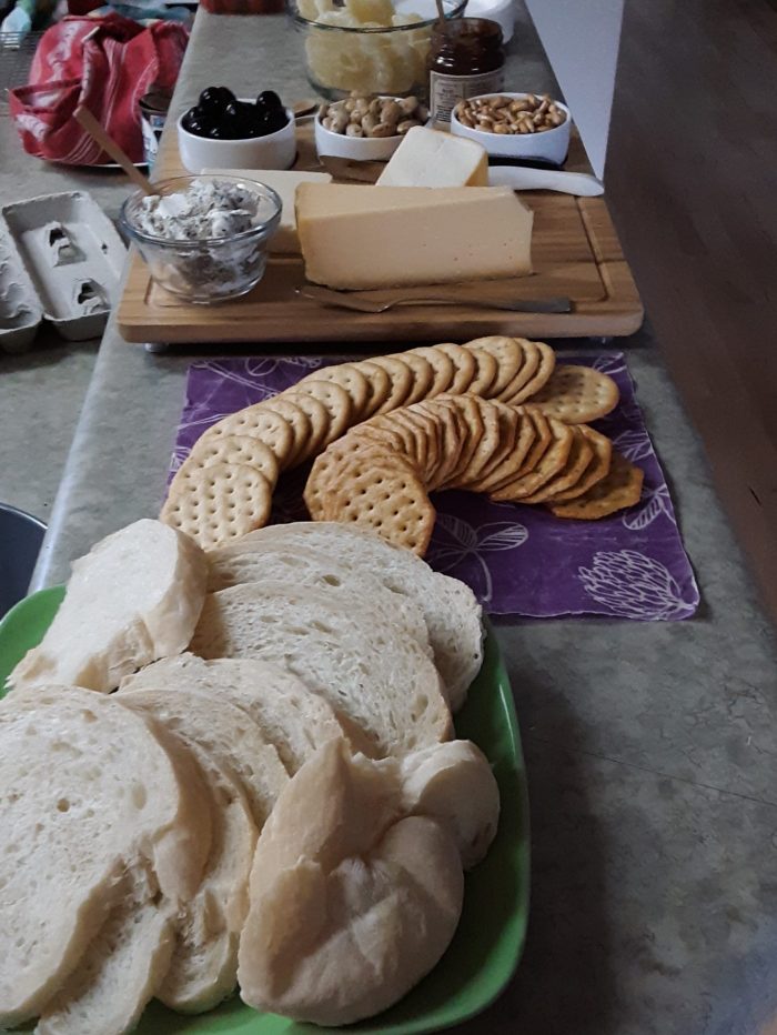 my pre-meal spread: bread, crackers, cheese plate, and other snacks