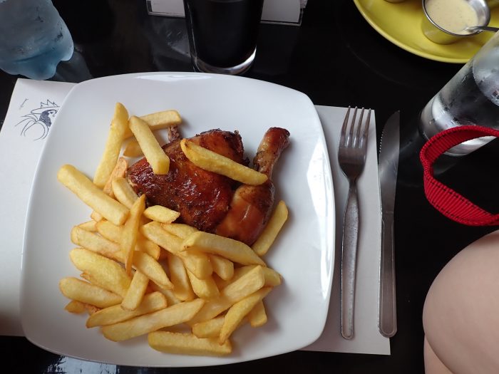 a plate of roast chicken and french fries