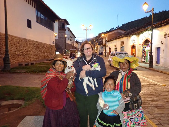 me holding a baby goat and standing with three indigenous women