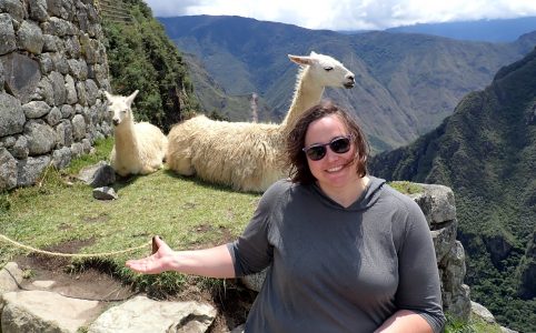 me seated in front of two llamas