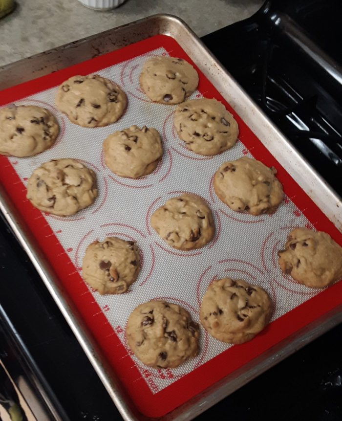 a sheet pan with 12 chocolate chip cookies