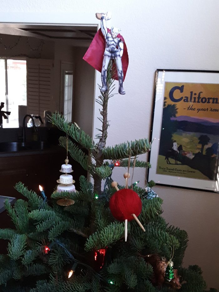 a Thor doll perched on the top of our christmas tree