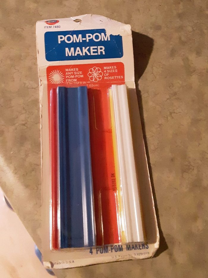a pom pom maker, in a package that looks at least 30 years old
