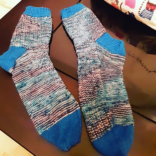 blue and white variegated socks with blue cuffs, heels, and toes