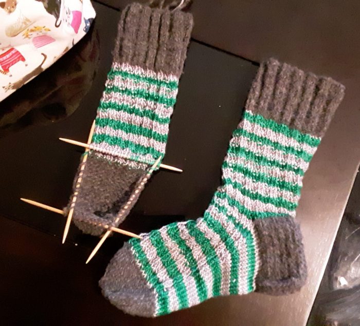 one fully knitted sock and one halfway knit