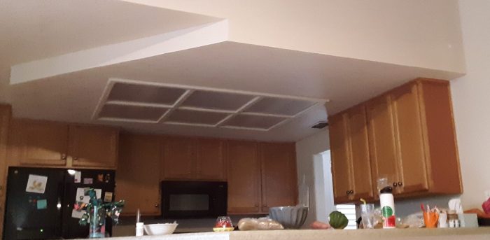 beofre remodeling: a box in the center of the kitchen that contains florescent fixtures