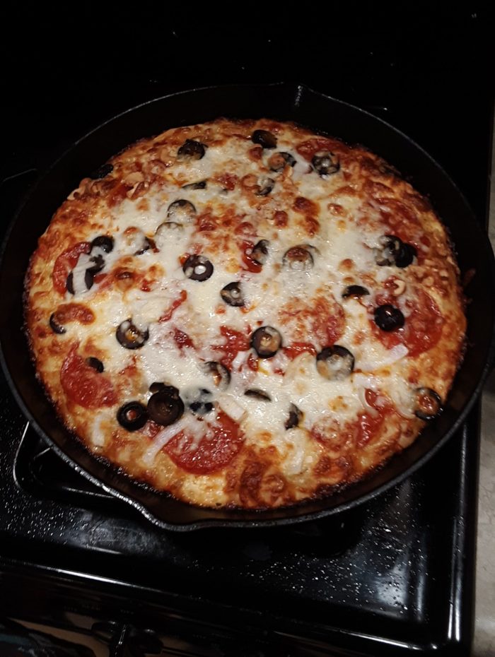 a skillet-baked pizza, still resting in the skillet