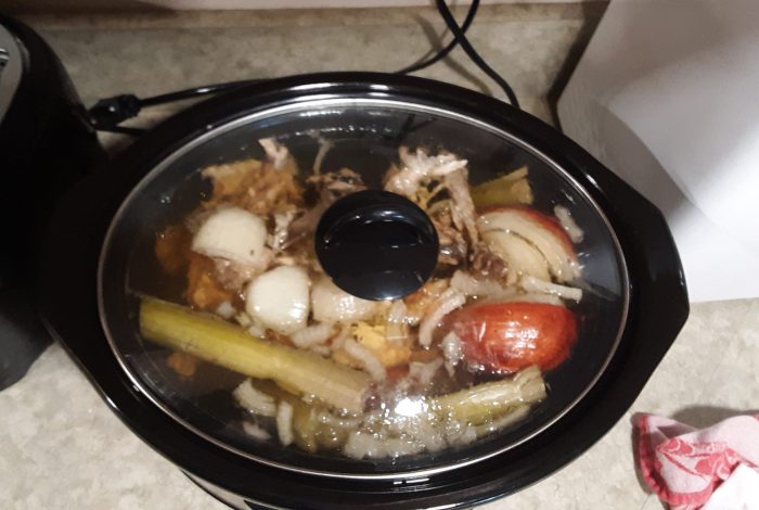 chicken stock simmering in the slow cooker