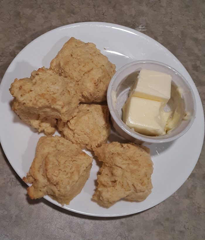 biscuits on a plate along with a dish of butter