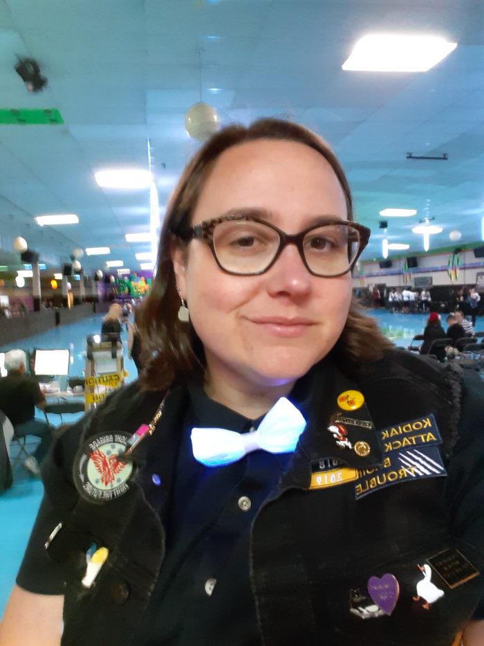 me, smiling at the camera, wearing my statement jacket thats covered in patches and pins