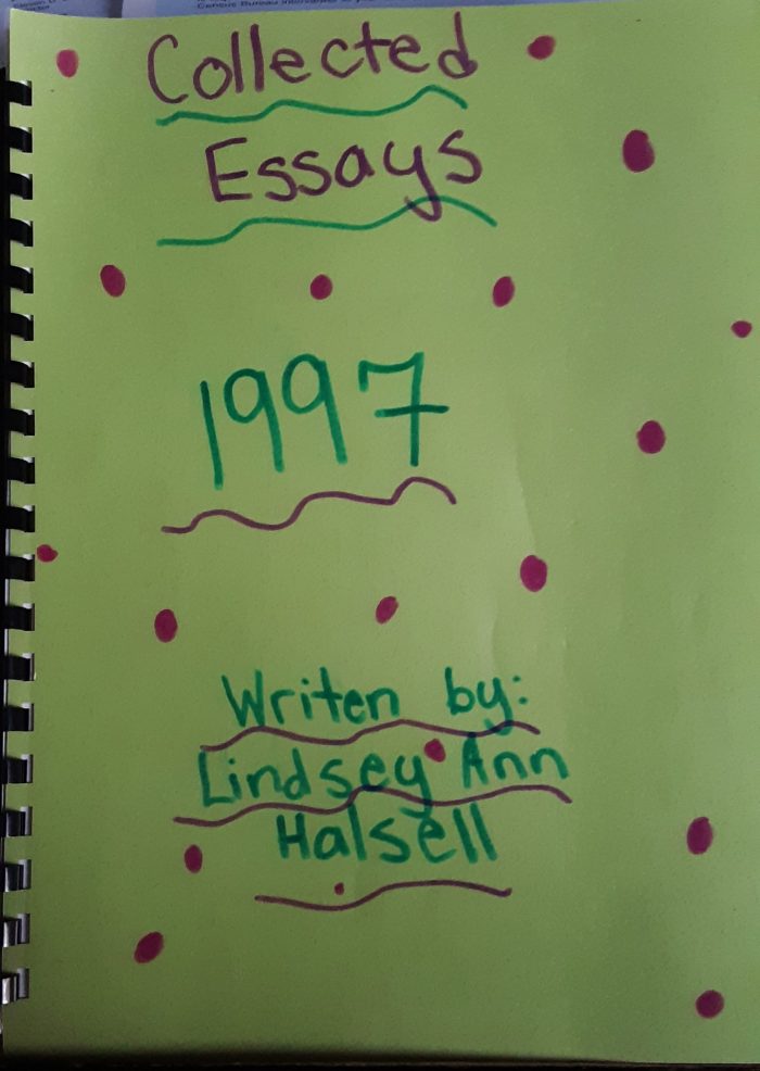 green construction paper with text in marker "Collected Essays. 1997. Written by: Lindsey Ann Halsell"