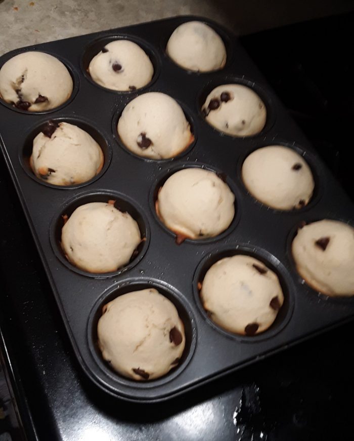 a muffin tin of 12 chocolate chip muffins