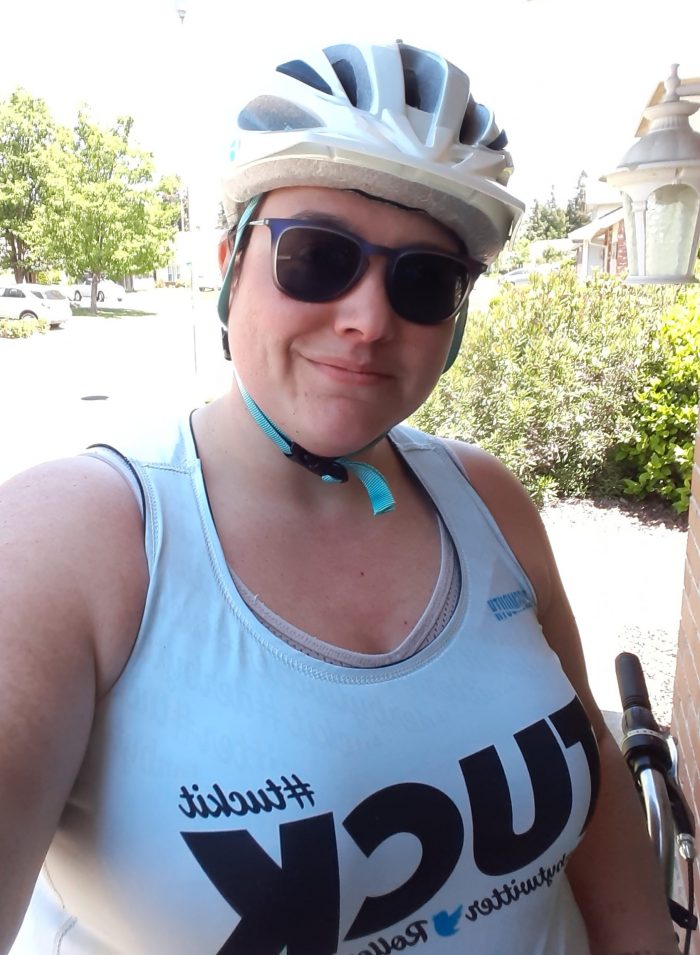 me, wearing a bike helmet having returned from a ride