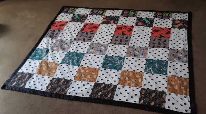 cat quilt laid out flat on the floor