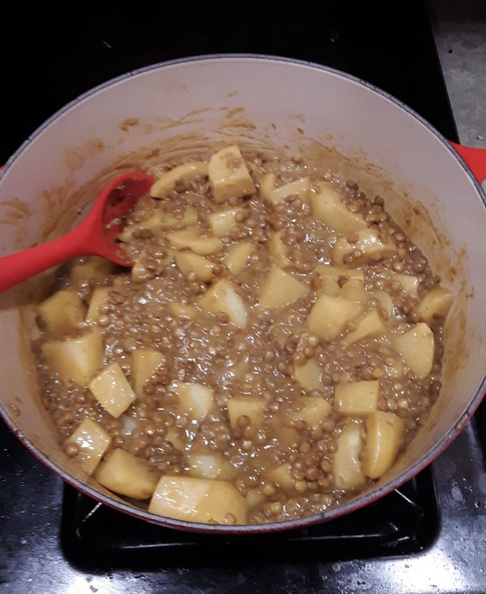 a large pot of potato and lentil curry