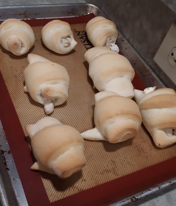 a pan of chicken roll-ups