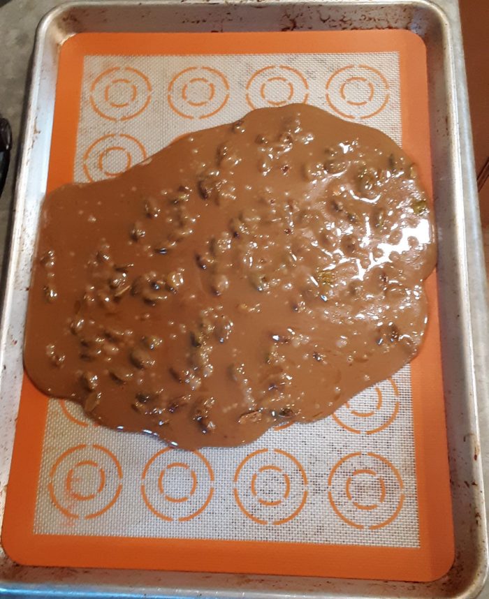 pistachio toffee cooling on a sheet pan