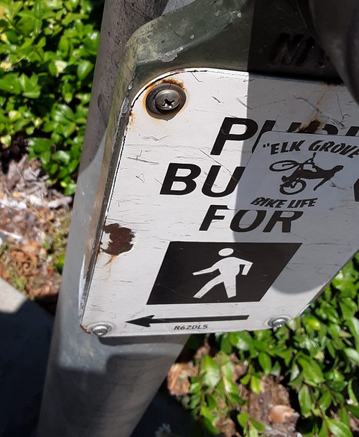 sticker that says "elk grove bike life" on a crosswalk button