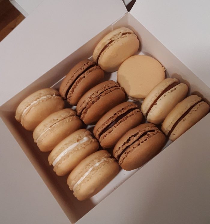 A box of 12 macarons, 4 of each of the three flavors