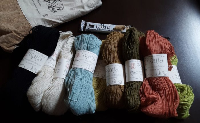 A pile of yarn skeins in various colors. The tags say "Katla, Icelandic lambswool"