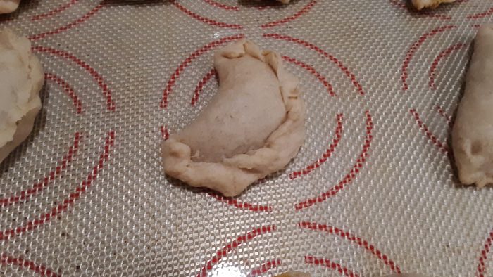 pumpkin empanadas cooling on the sheet pan