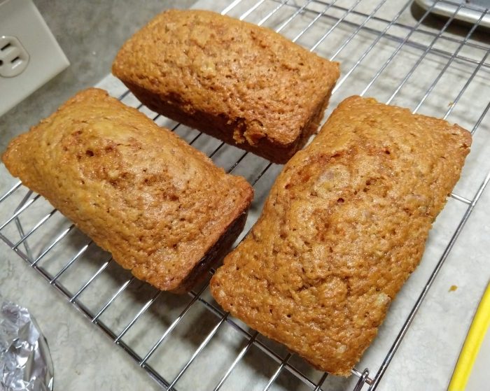 three mini loaves of carrot bread, cooling on a wire rack