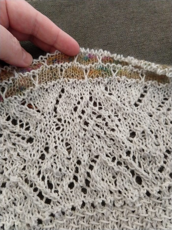 details of a shawl in progress with a pattern that sort of looks like stained glass