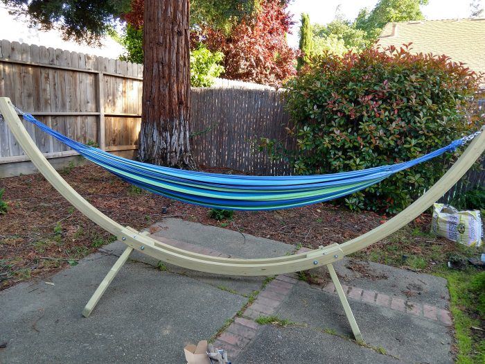 a large, wooden hammock stand set up on my back patio