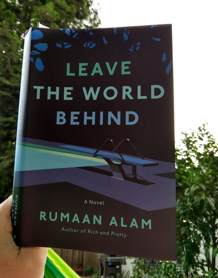 hardback book: Leave the World Behind. Photo taken outside and there are trees in the background