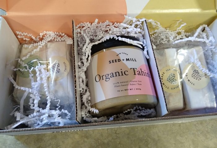 a festive box containing a jar of tahini and four flavors of halva from Seed + Mill