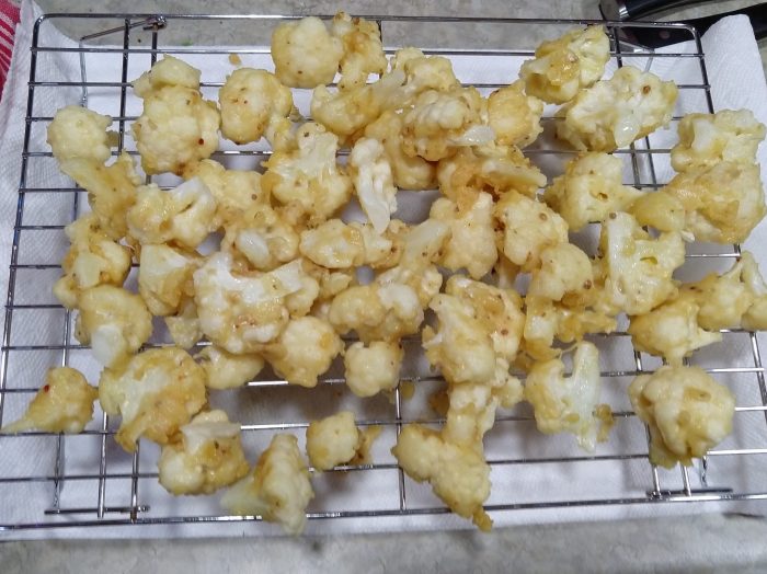 fried cauliflower on top of a wire rack