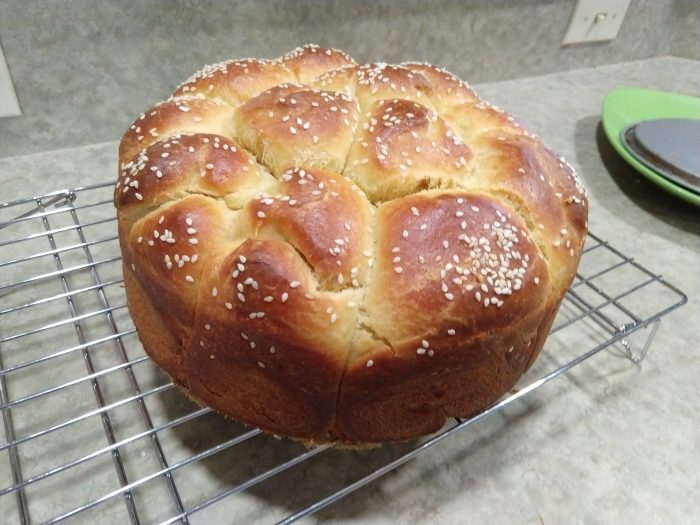 a bunch of rolls baked together (tear-and-share), pleasantly browned and topped with sesame seeds