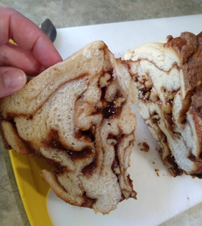 a slive of the cinnamon babka, revealing thick swirls of cinnamon, and also showing how the loaf collapsed
