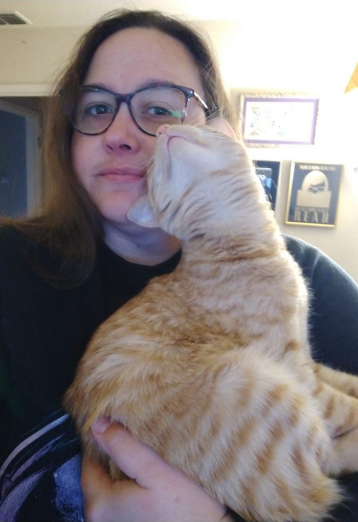 I'm holding Fritz the cat in my arm, he's sitting in it and rubbing his face against mine, exposing his neck and chin to the camera