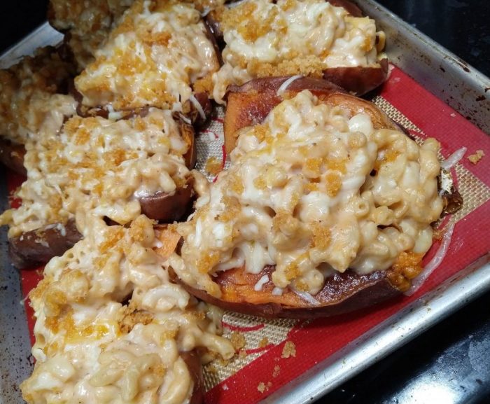 a sheet pan of sweet potatoes cut in half and piled high with macaroni and cheese