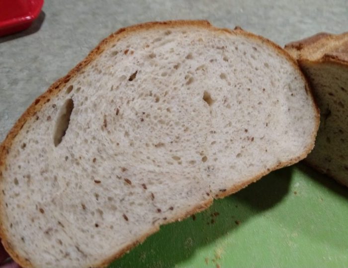 A loaf of rye bread cut in half to reveal the inside