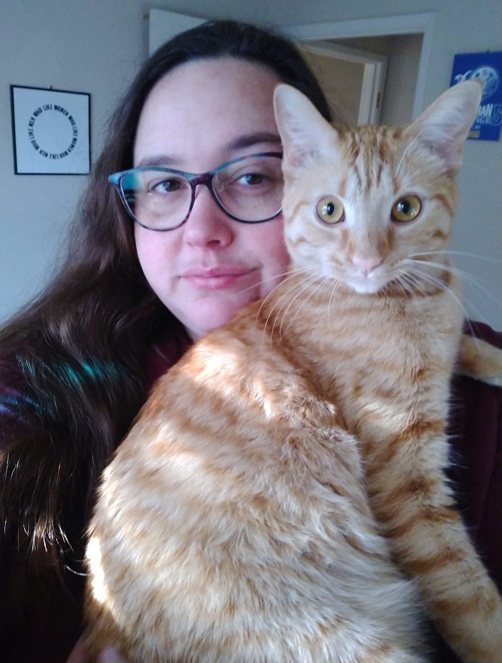 me holding Fritz the cat. Fritz is wide-eyed and looking directly at teh camera.