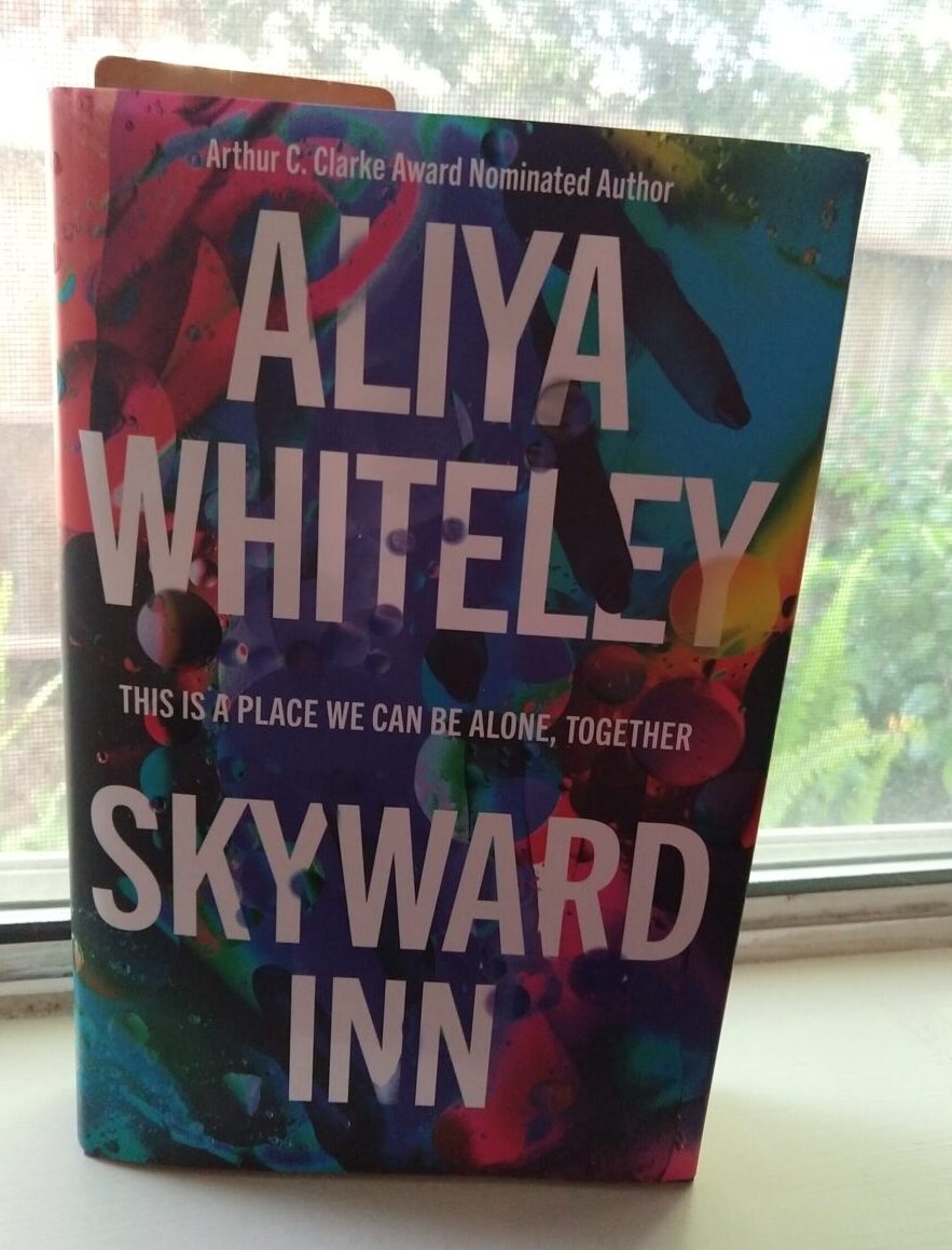 hardcover book: Skyward Inn by Aliya Whitely. The cover is a bunch of colorful blobs