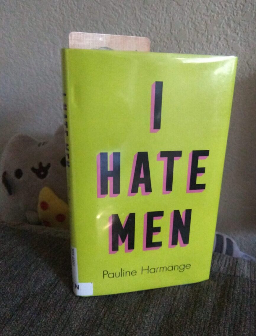 small, hardback book "I Hate Men." A bright yellow cover with big black letters