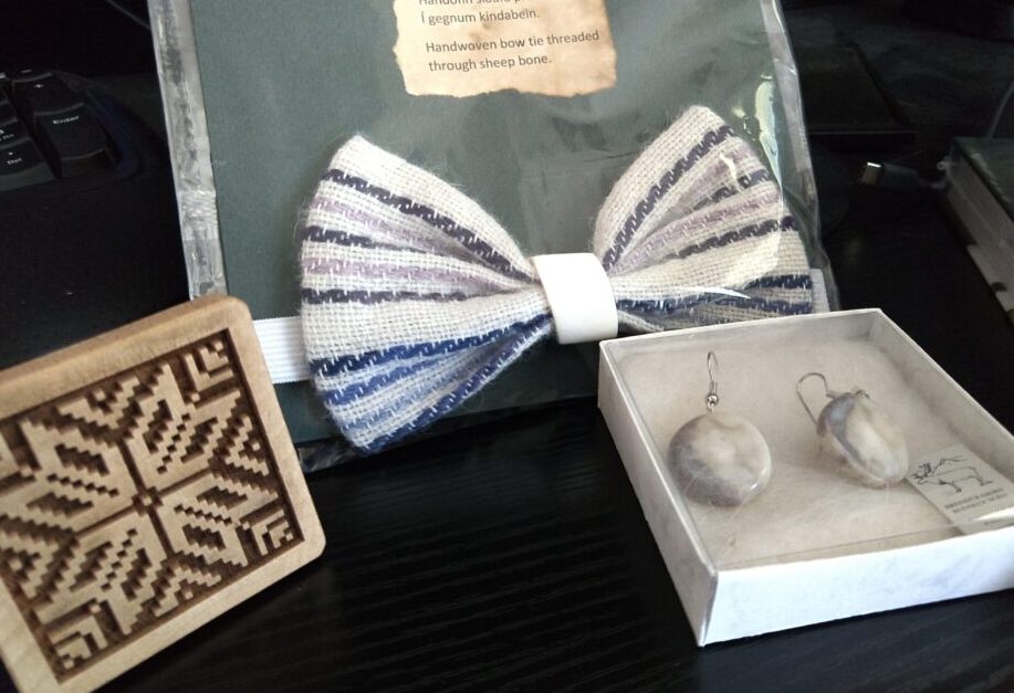 a cookie stamp with a knitting design, a woven bow tie, and earrings made from reindeer antlers