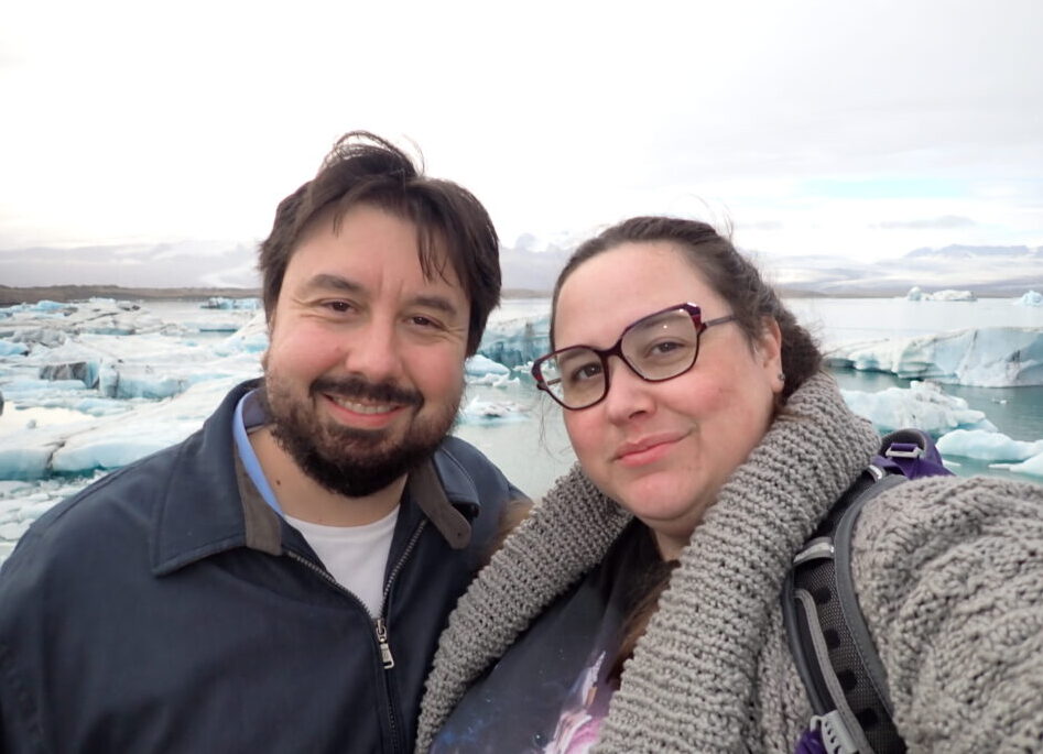 Kirk and I standing together in front of the camera, looking tired and trying to look like we're having fun. The glacial lake is in the background.