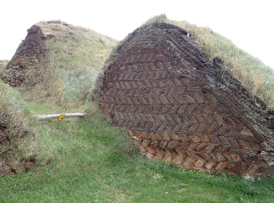 Mounds of earth covered in grass. The earth has been stacked in a sort of fishbone pattern